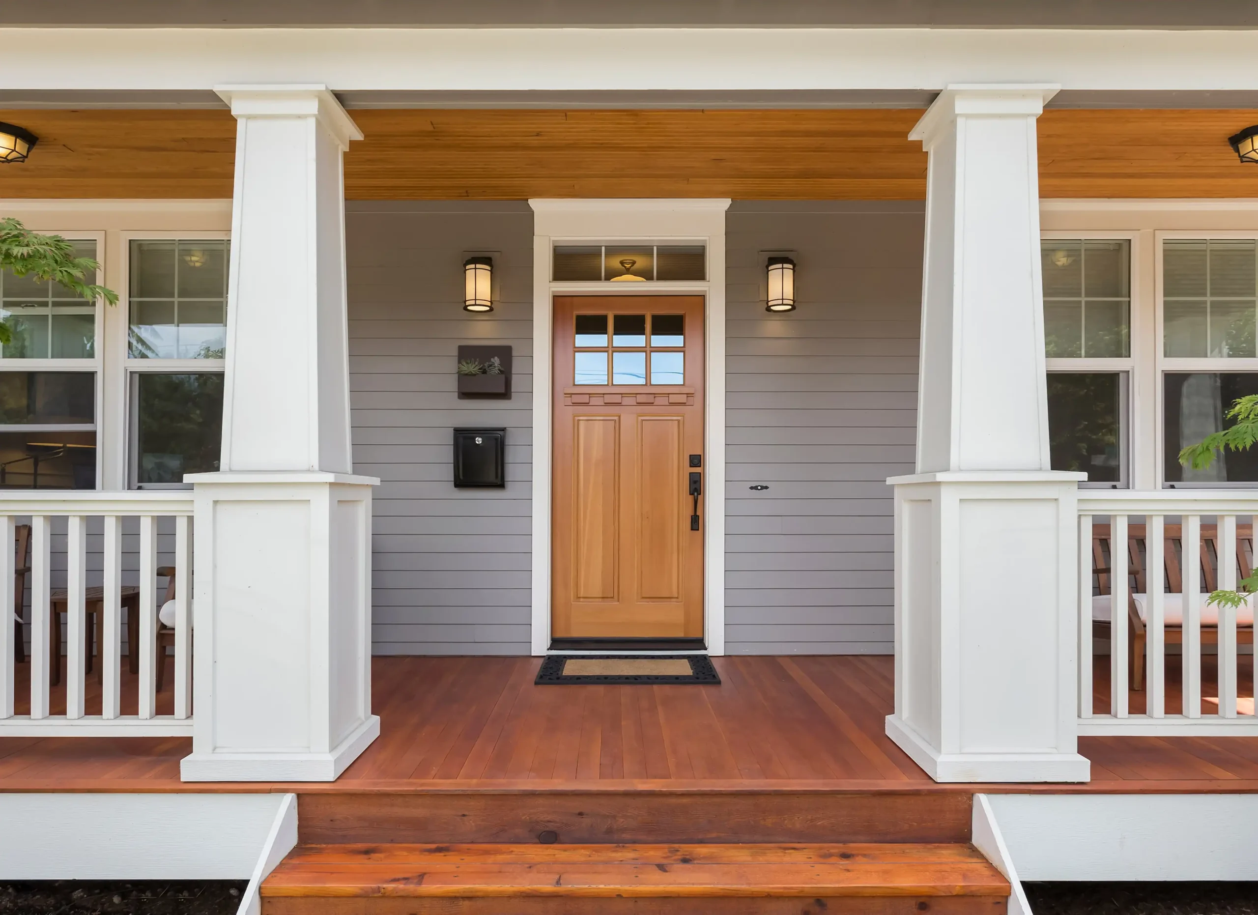 Craftsman-style front porch of a Melbourne home painted by GoBrush Painting – Exterior painting with grayish-blue siding